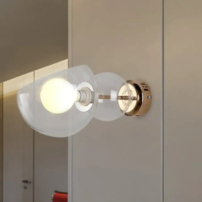 Modern wall lamp with amber glass shade and brass metal base ideal for bedroom sconce lighting