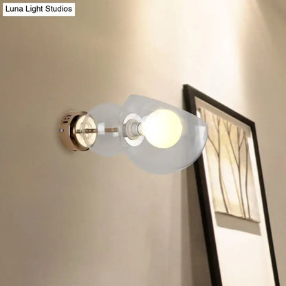Postmodern wall lamp with amber glass shade and brass-finished base designed as a bedroom sconce light