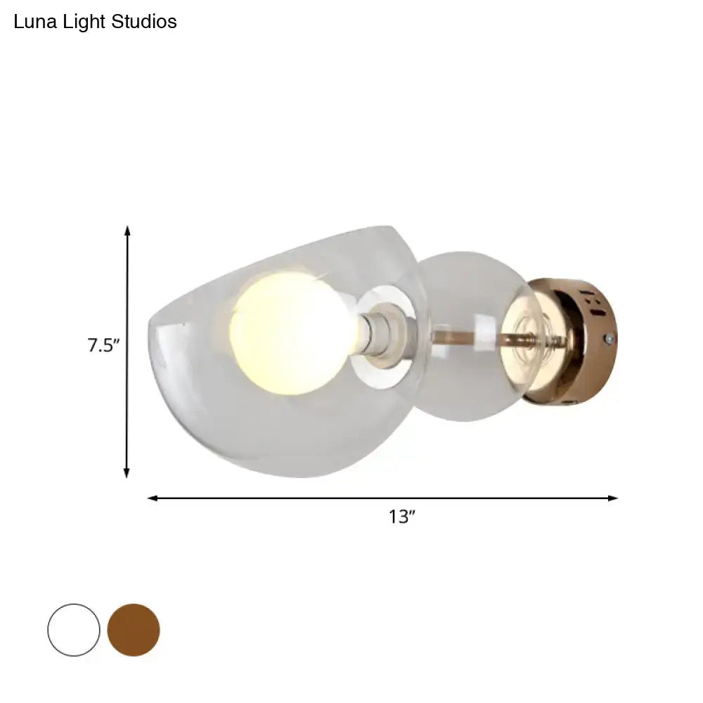 Postmodern brass amber glass wall lamp with frosted amber glass shade and exposed bulb in curved design for bedroom