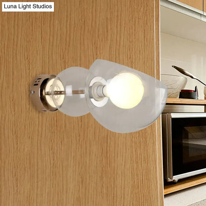 Postmodern wall lamp with amber glass shade and brushed brass base featuring two frosted glass sconce lights