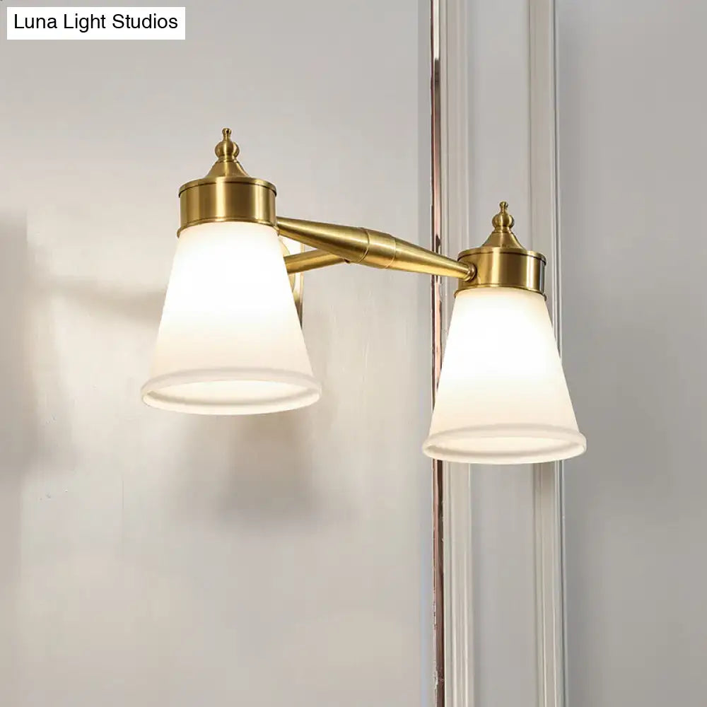 Postmodern brass wall sconce with two frosted cream glass shades for bathroom vanity lighting