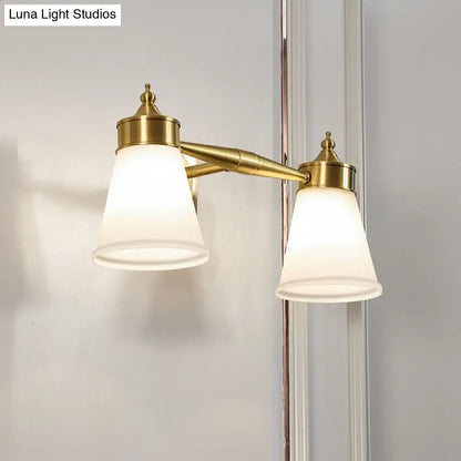 Postmodern brass wall sconce with two frosted cream glass shades for bathroom vanity lighting