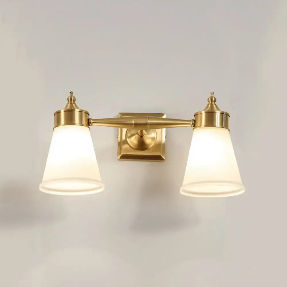 Postmodern brass wall sconce with two frosted cream glass shades for bathroom vanity lighting