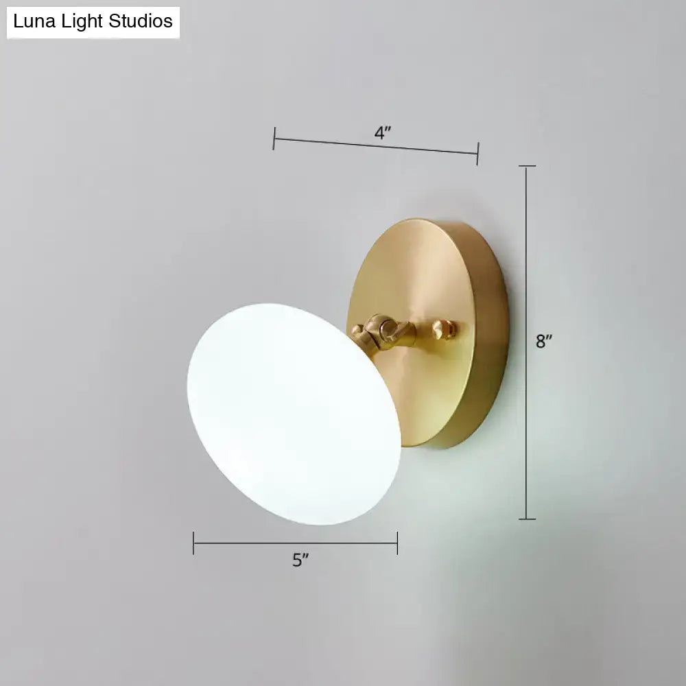 Modern brass and glass wall sconce with frosted white oval shade includes bedroom light type bulb included