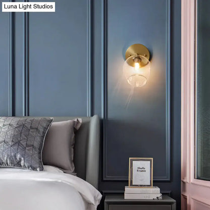 Postmodern brass and glass wall sconce with gold tone, clear glass globe, exposed bulb included light type for bedroom