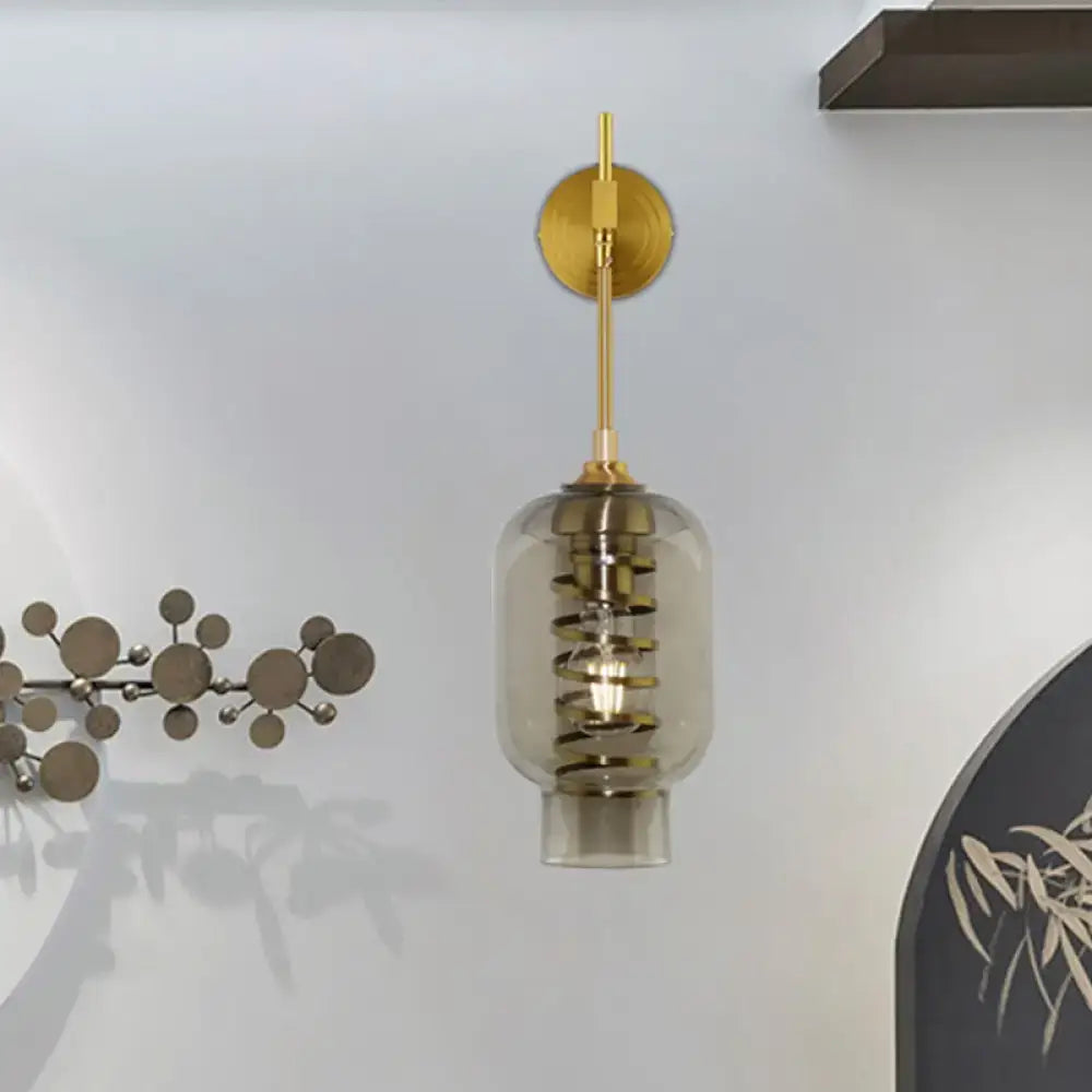 Postmodern brass wall lamp with smoke gray glass shade and gold metal stem for tea room lighting