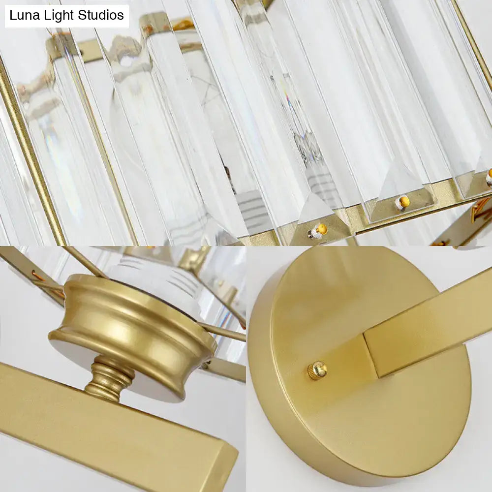 A modern chandelier with clear crystal prisms and polished brass black metal accents for bedroom lighting