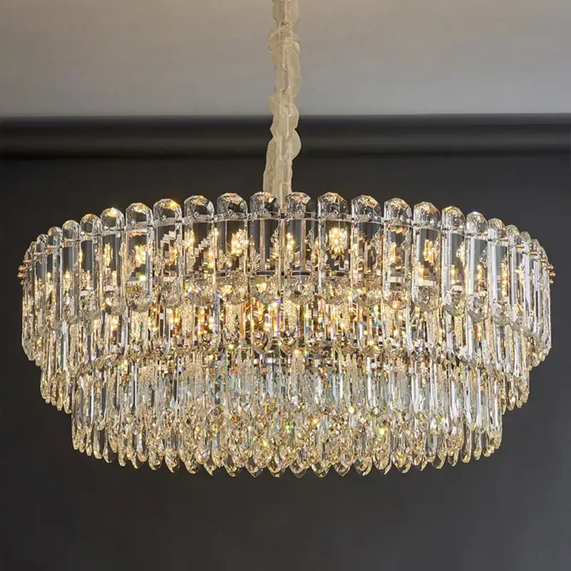Postmodern clear and gold decorbites crystal chandelier with tiers of faceted glass rods and teardrop crystals for dining room