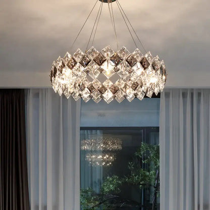 A modern decorbites crystal chandelier with clear and smoky faceted glass in overlapping diamond patterns for living rooms