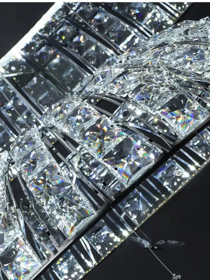A postmodern pendant light featuring a crystal butterfly design with clear faceted crystals on a black metal frame