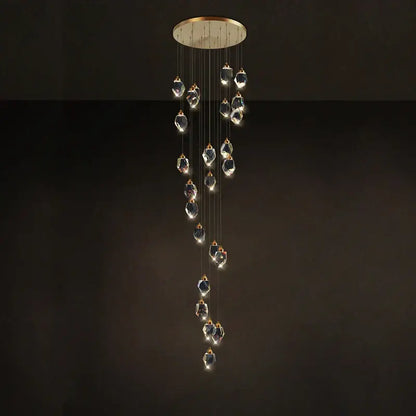 A postmodern crystal stone copper chandelier with gold-toned mount and cascading clear glass pendants for staircase lighting
