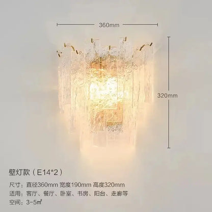 A warm glowing wall-mounted lamp with textured frosted glass and gold accents in decorbites crystal chandelier style