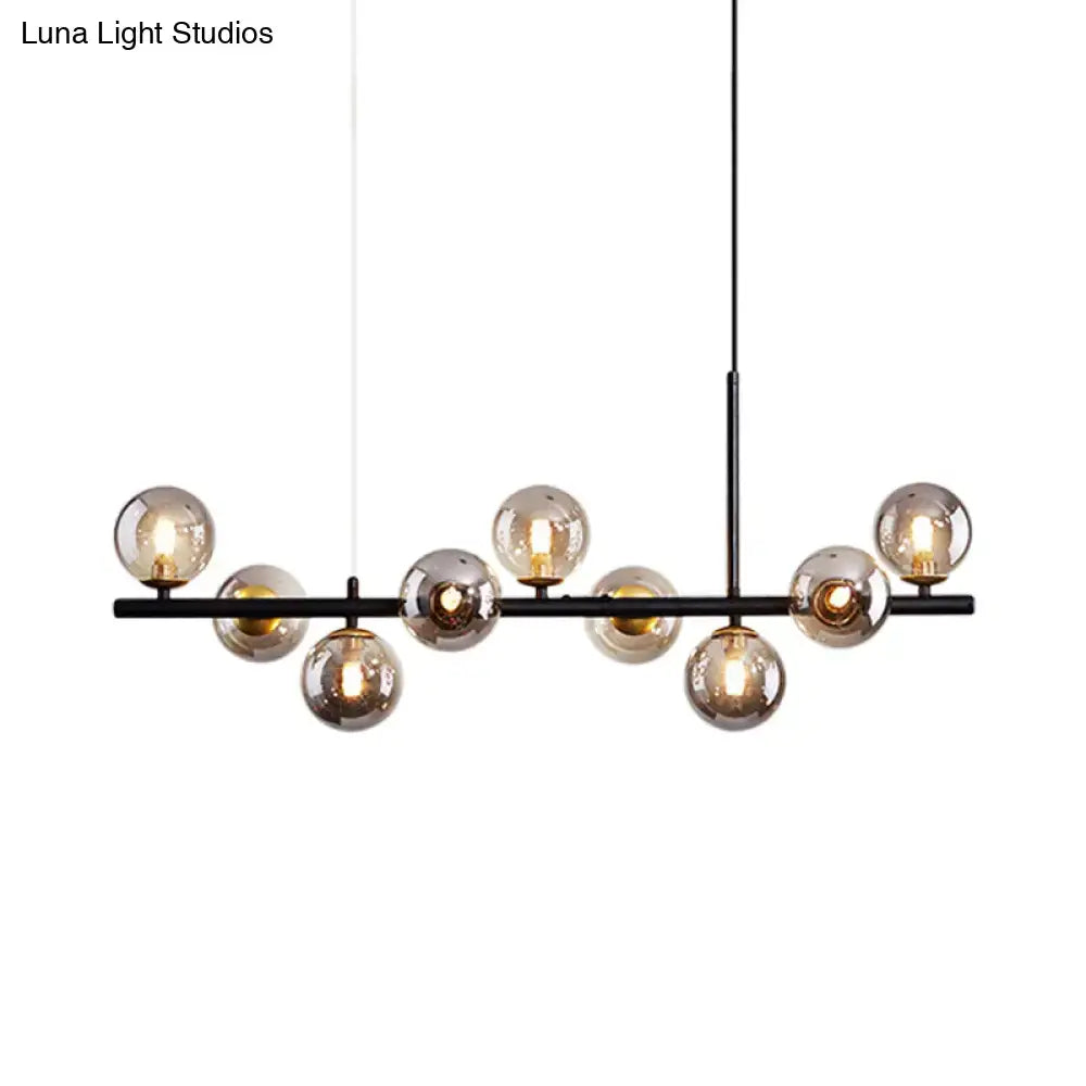 Modern black metal pendant light with multiple spherical amber glass globes from DecorBites postmodern collection