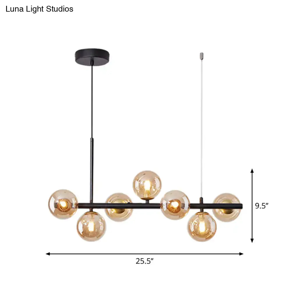 Modern black metal pendant light with seven amber glass globe bulbs by DecorBites™ for kitchen use