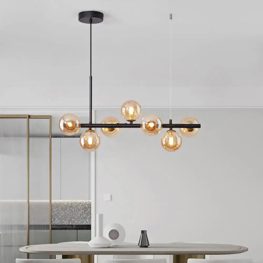Modern black metal pendant light with multiple amber glass globe bulbs for kitchen by decorbites
