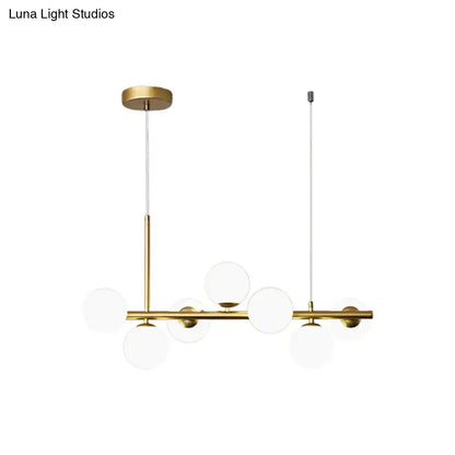 DecorBites modern brass pendant light with clear glass globe shades in gold finish for kitchen lighting