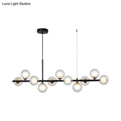 Black modern DecorBites pendant light with clear glass globe bulbs and brass accents for kitchen use