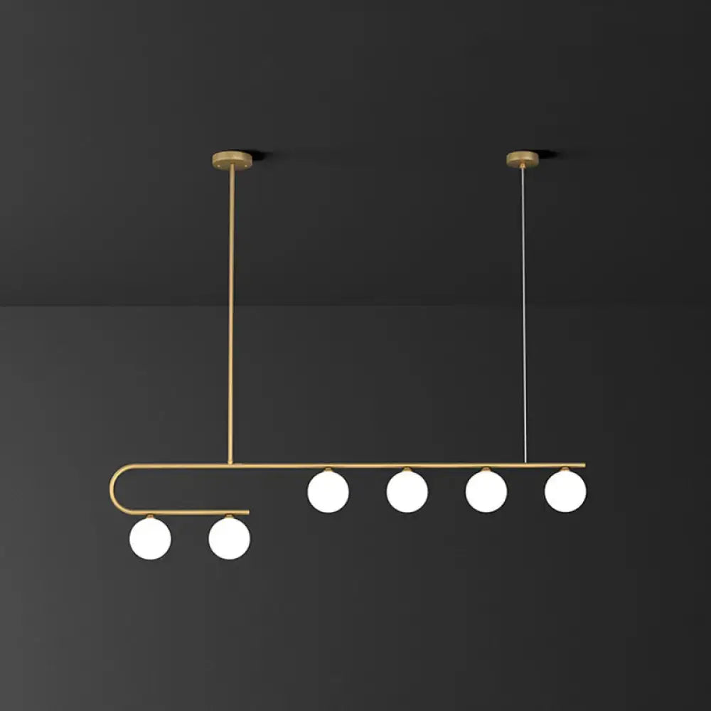 DecorBites postmodern gold linear island pendant light with brass frame and five ivory ball glass bulbs