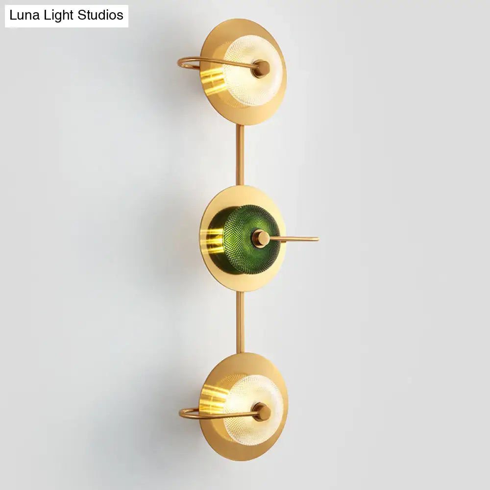 Postmodern gold wall sconce with three glass disc shades includes central olive textured and frosted clear lamps