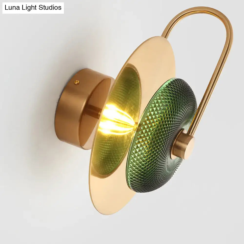 Postmodern gold wall mounted lamp with olive glass disc shade and curved brass arm for living room wall sconce