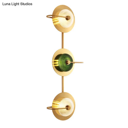 Postmodern gold wall mounted lamp with three glass disc shades in olive green textured and frosted white finishes