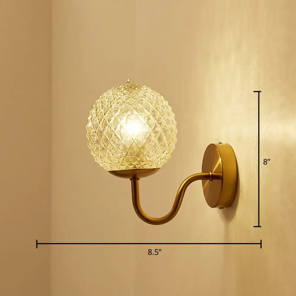 Postmodern gold ball shaped wall sconce with textured glass shade and faceted crystal glass for bedroom lighting