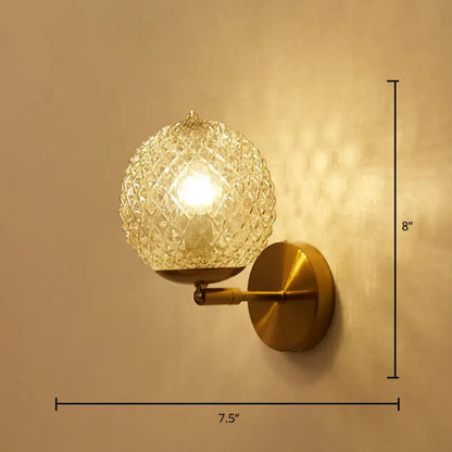 Postmodern gold wall sconce with ball shaped textured glass shade for bedroom lighting