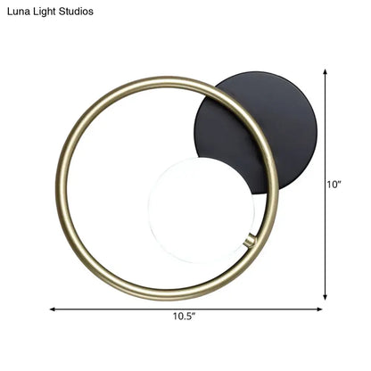 Postmodern wall mounted light with a brushed brass ring and black matte disc featuring integrated led source