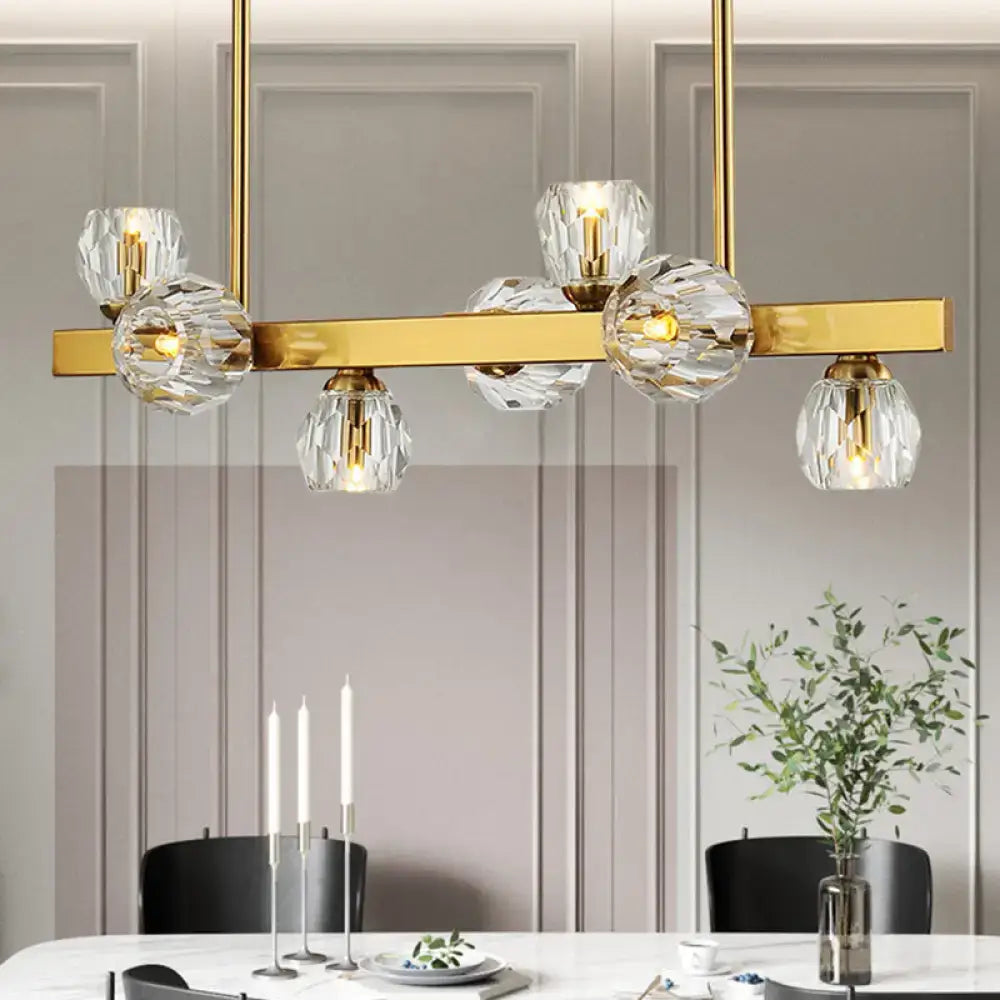 Gold-toned pendant light with clear faceted crystal globe shades featuring gold branch design for island lighting