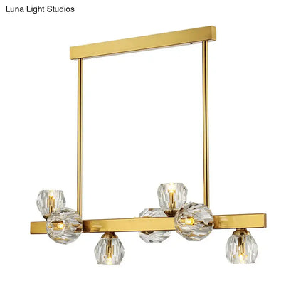 Gold-toned postmodern pendant light with faceted crystal globe shades in a gold branch design for island lighting