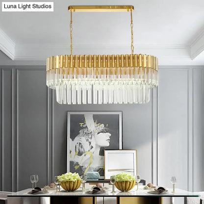 Postmodern gold-toned rectangular light fixture with cascading clear crystal prisms for dining room island lighting