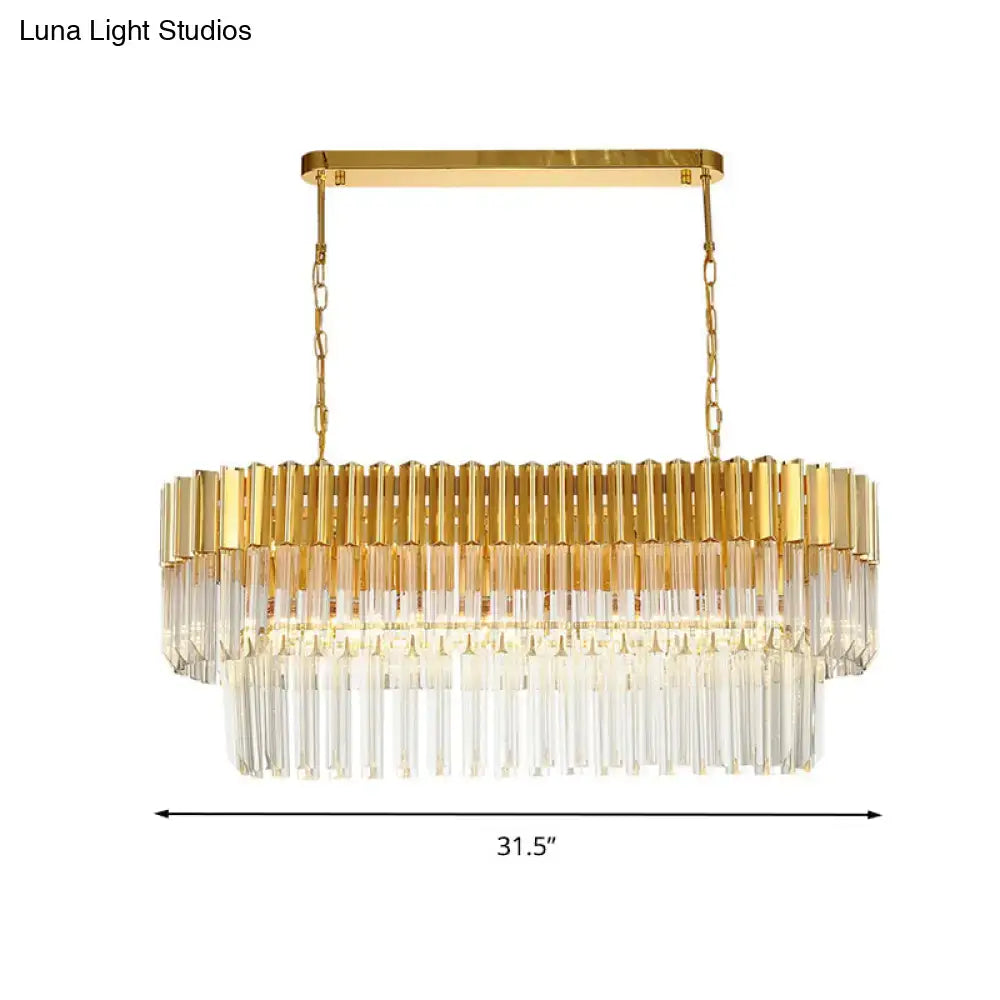 Postmodern gold rectangular light fixture with clear crystal prisms and polished brass frame for dining room island