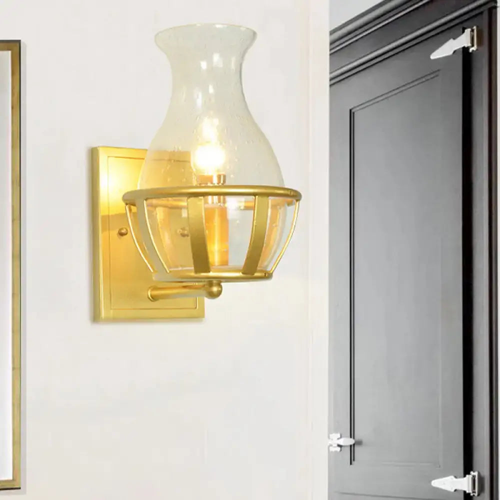 Postmodern gold clear glass wall lamp with metal frame and brass cage detailing for living room use