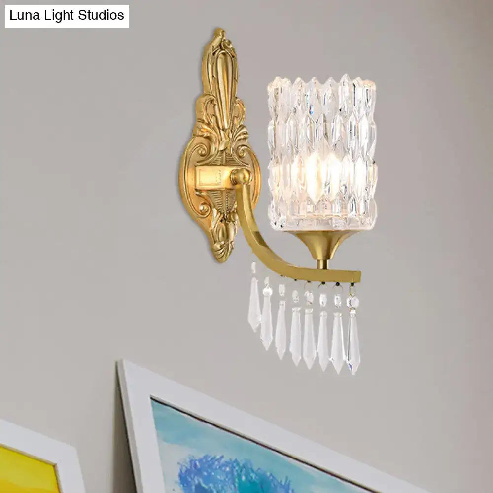 Postmodern gold column wall lamp with ornate finish faceted crystal shade and dangling teardrop crystals for bedroom lighting