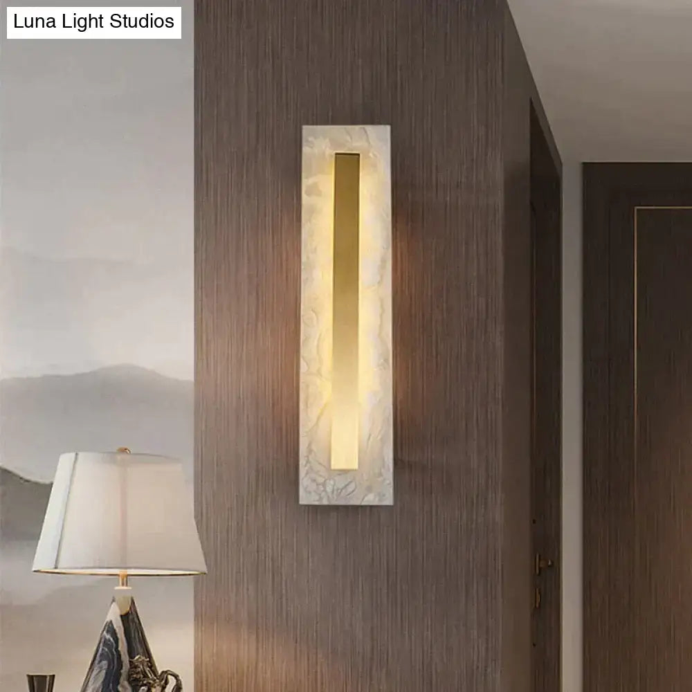 Postmodern wall lamp with copper marble wall finish and warm golden light for living room use