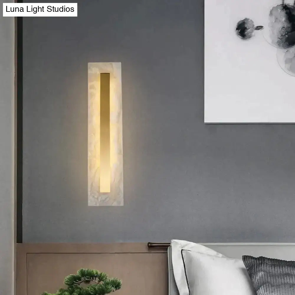 Postmodern gold copper marble wall lamp with a warm golden light in a polished white marble frame for living room use