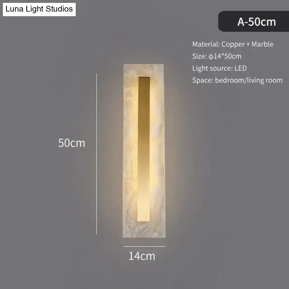 A sleek modern wall lamp with rectangular copper and marble design for living room featuring a copper marble wall style