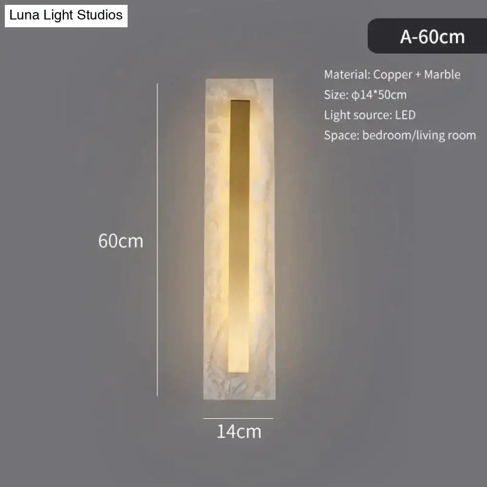 Postmodern wall lamp with a rectangular marble frame and copper strip emitting warm led light for living room use