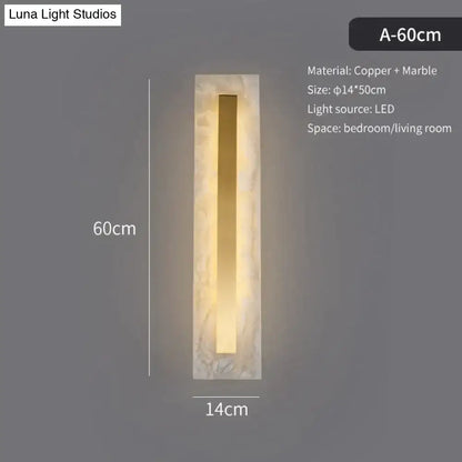 Postmodern wall lamp with a rectangular marble frame and copper strip emitting warm led light for living room use