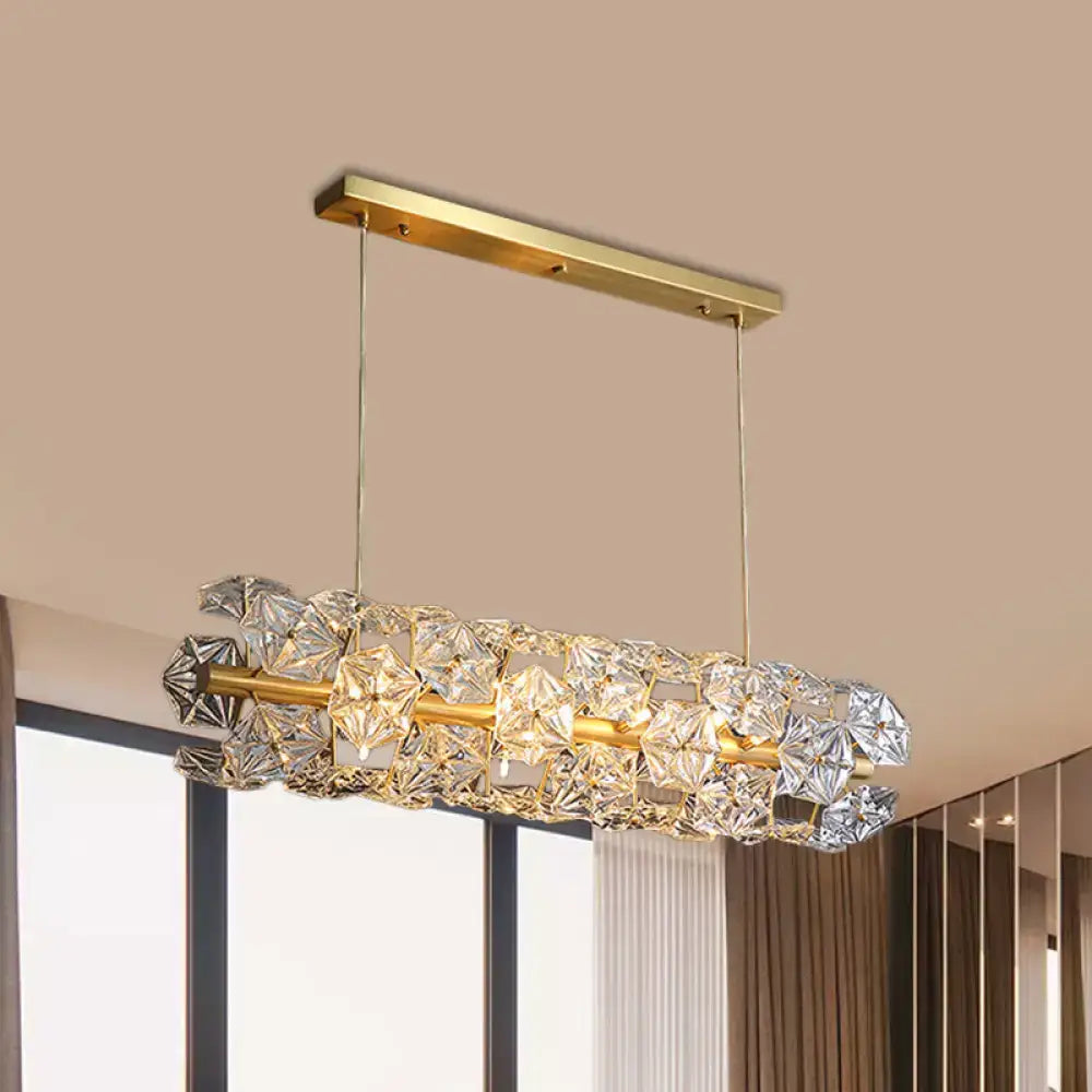 A modern decorbites™ postmodern brass pendant lamp with a gold frame and crystal hexagon shade for restaurant lighting