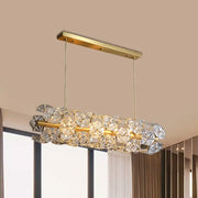A modern decorbites™ postmodern brass pendant lamp with a gold frame and crystal hexagon shade for restaurant lighting