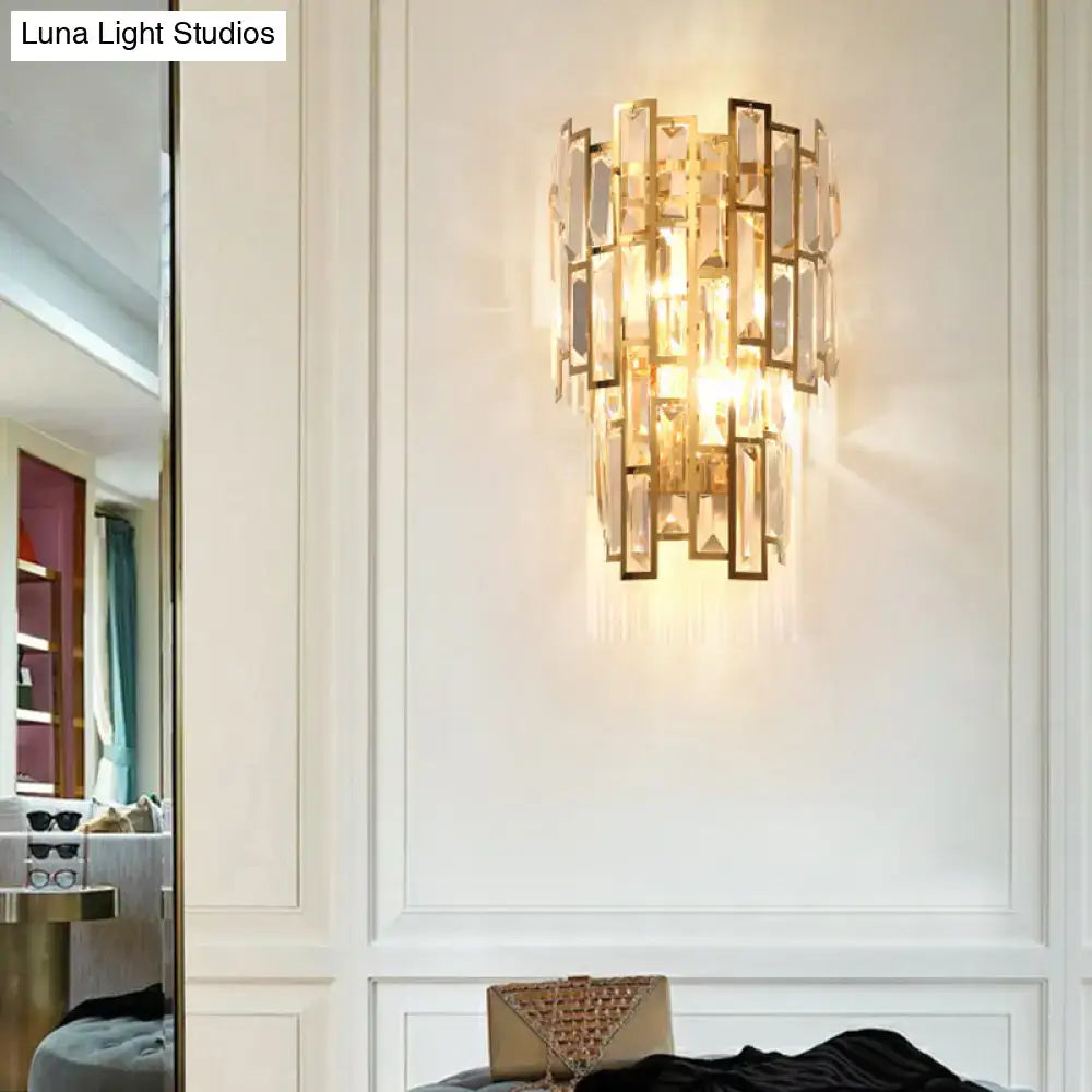 Postmodern gold-toned sconce light fixture with cascading rectangular crystal panels for living room wall lighting