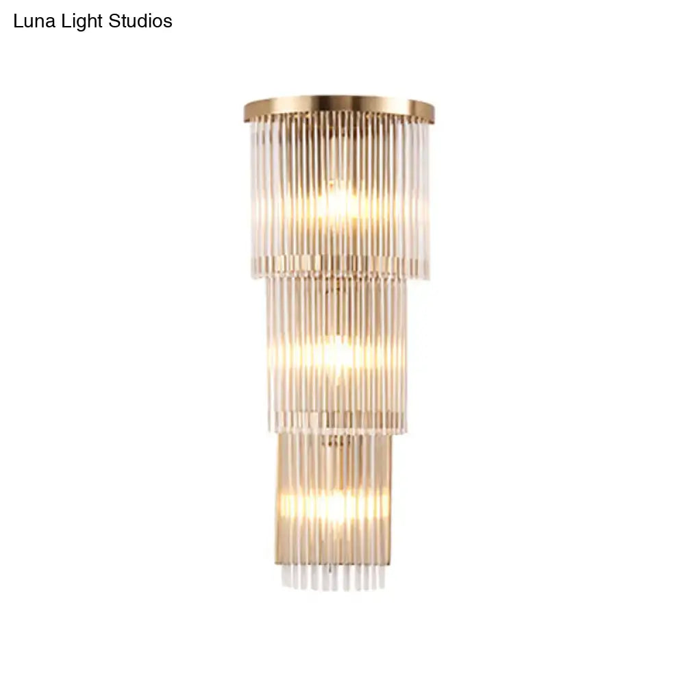 Postmodern gold crystal triangle wall light with tiered cascading glass rods emitting warm glow for living space