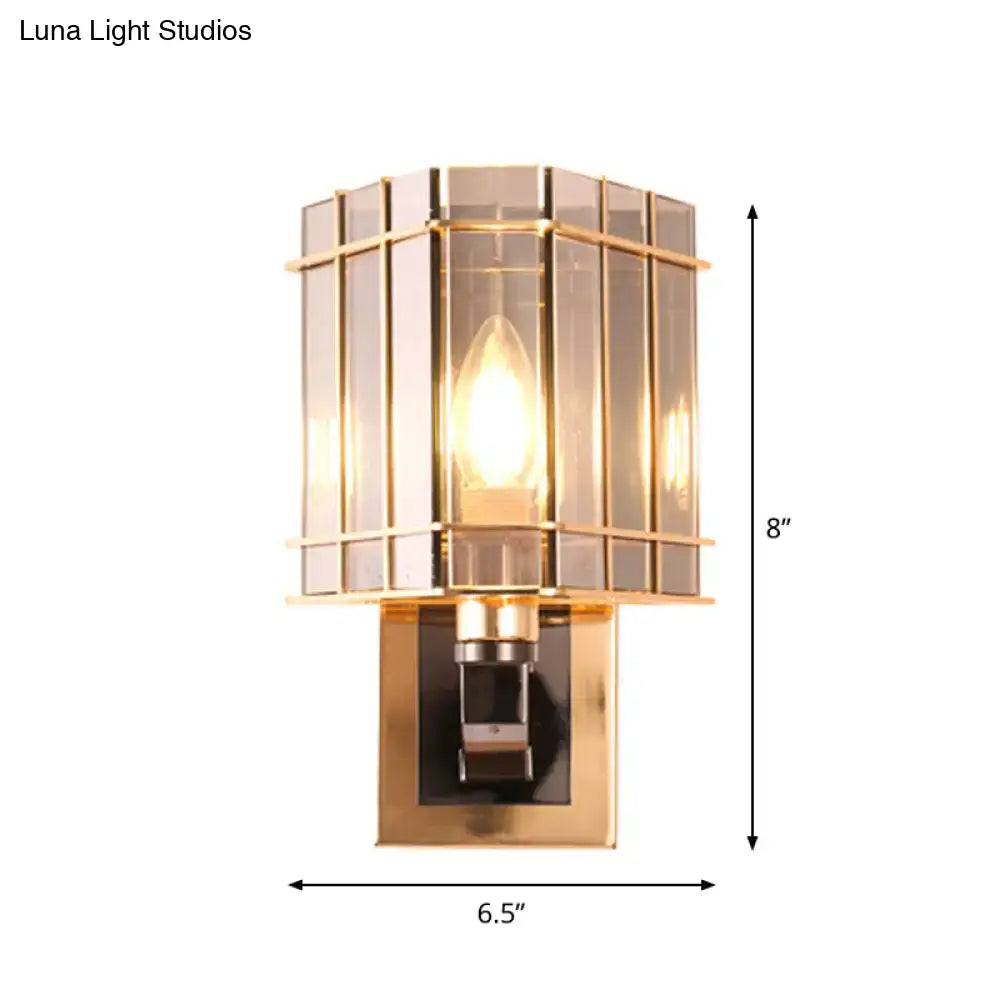 Postmodern gold-toned wall light with a rectangular segmented glass shade and brushed metal base for chic living space