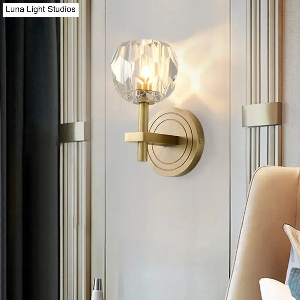 Postmodern gold crystal wall mounted light featuring a faceted crystal globe shade for living room use