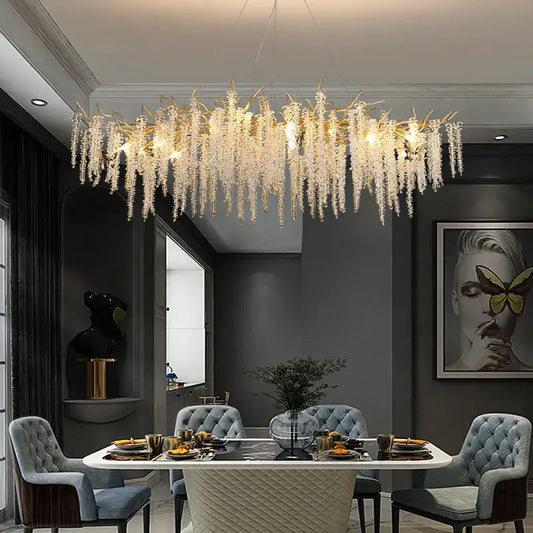 A postmodern gold-toned decorbites crystal chandelier with cascading strands for elegant dining room lighting