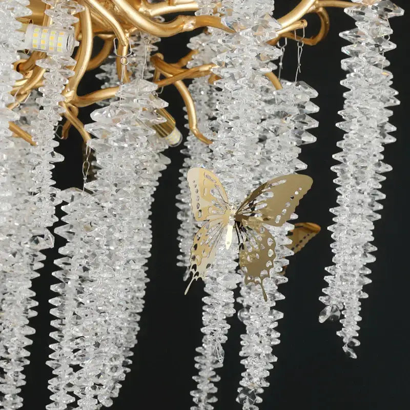 Golden butterfly ornament hanging from a decorbites crystal chandelier for dining room postmodern gold decorbites crystal chandelier