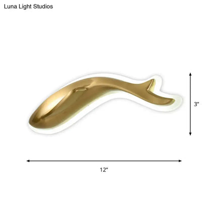 A sleek gold ceramic dolphin wall lighting fixture with glossy finish and elegant curves for bedroom sconce lighting
