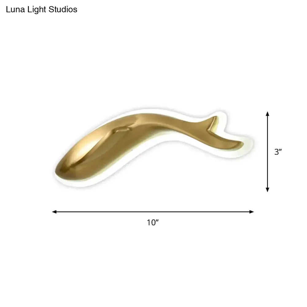 A sleek gold whale-shaped wall lighting fixture with a smooth glossy finish for modern bedroom sconce lighting