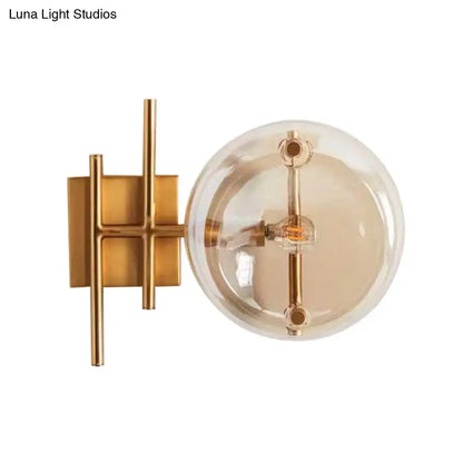 Postmodern gold double ball wall mounted light with amber glass globe and geometric metal bracket wall lamp for bedroom